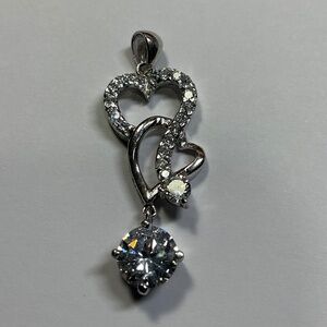 Sterling Silver intertwined open hearts vertical pendant with clear stones. 1.5”
